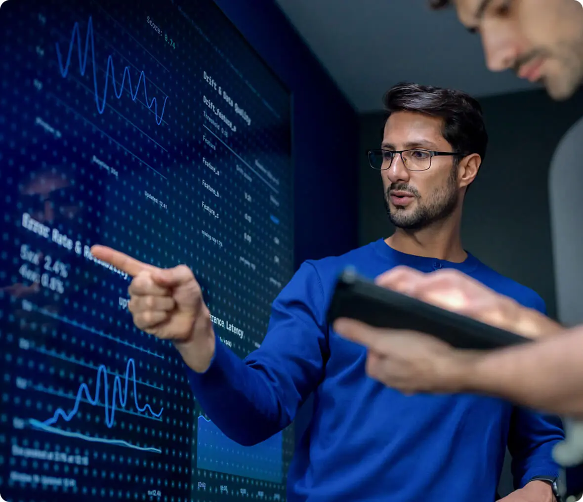 Man explaining data on digital screen