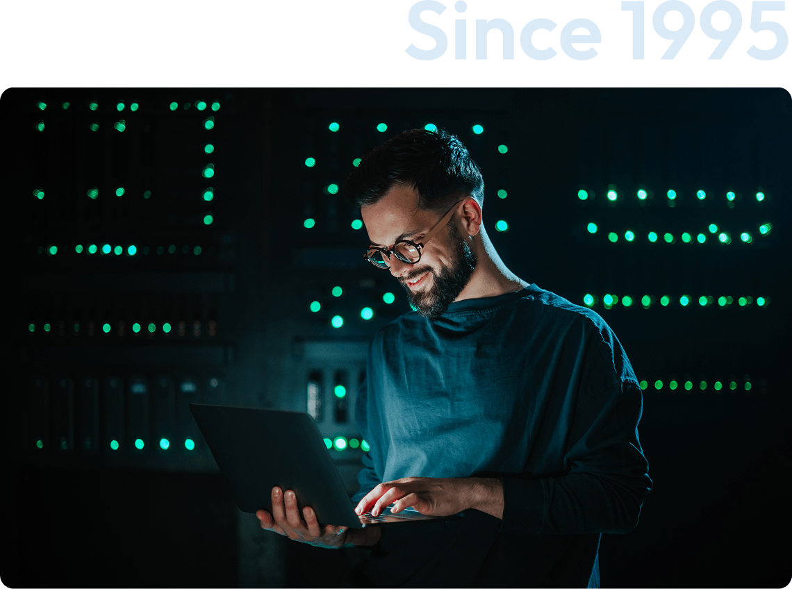 Person using laptop in server room