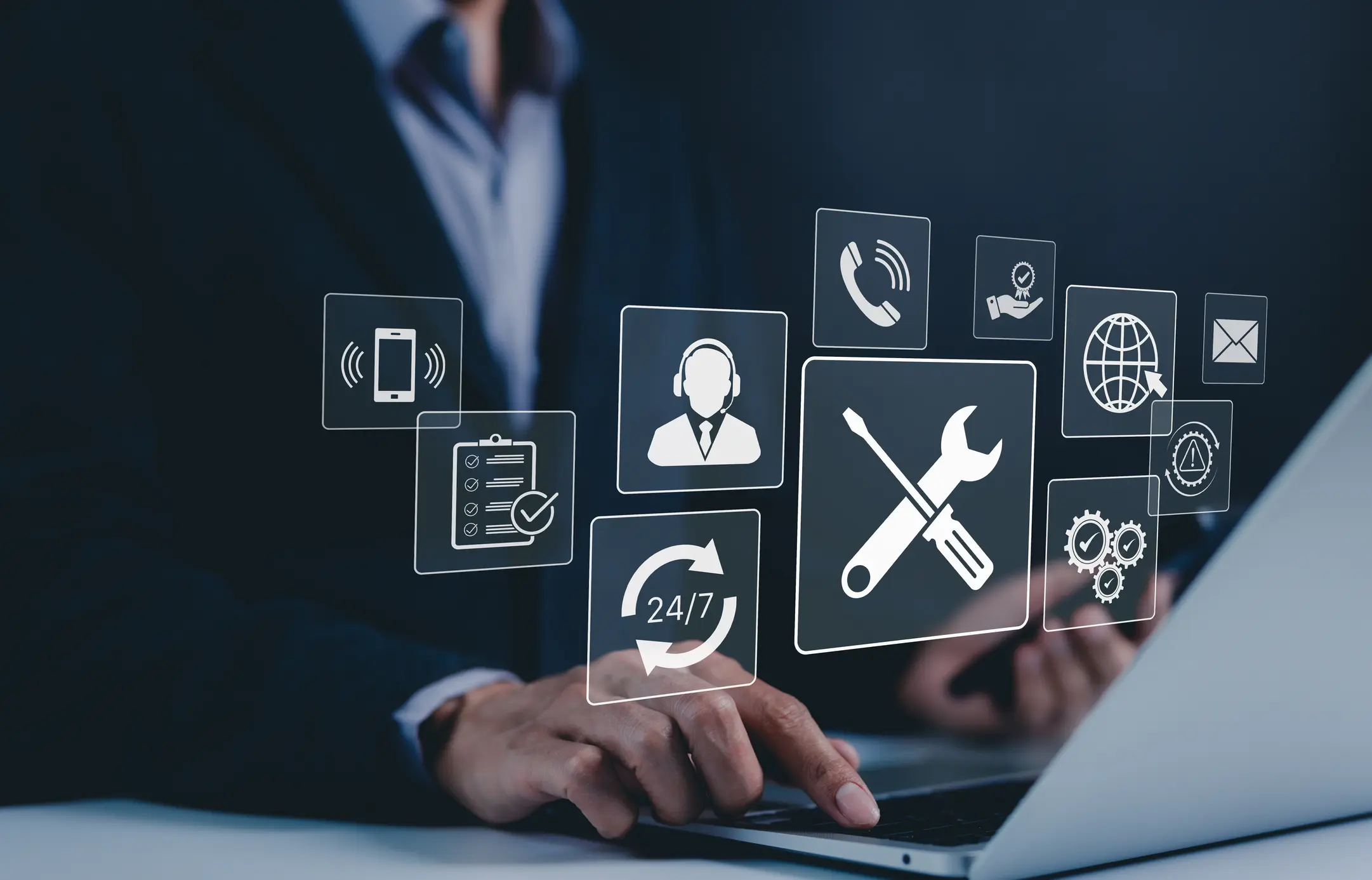 Person using laptop with technical support icons