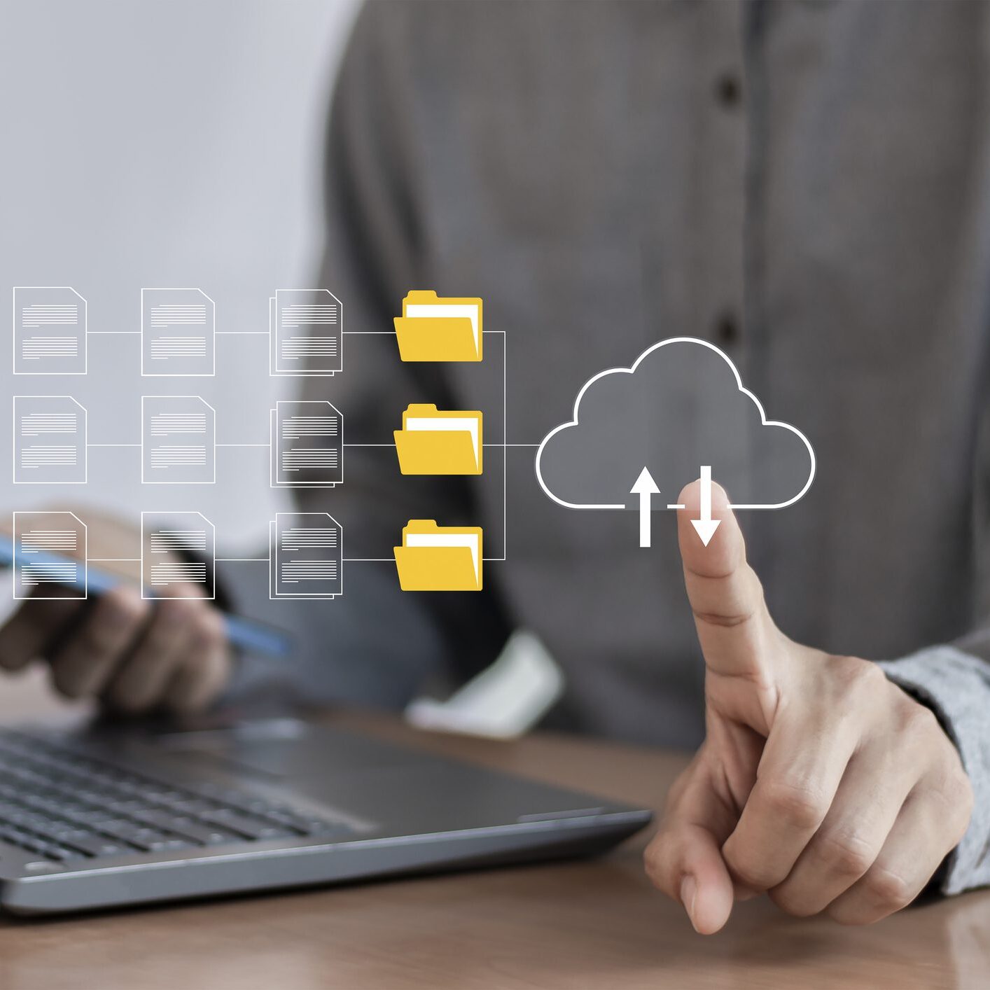 Hand touching cloud storage icon on laptop
